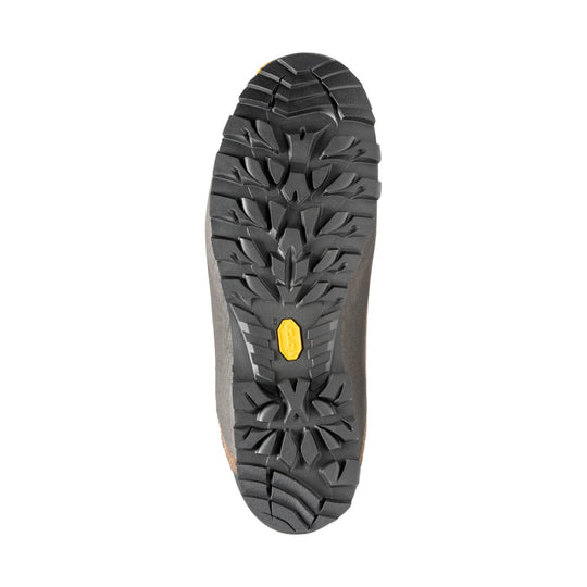 Boot outsole with deep black lug tread and a yellow Vibram logo insert