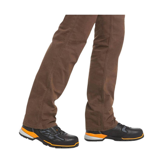 Brown work pants with straight legs and black work shoes with orange and gray accents.