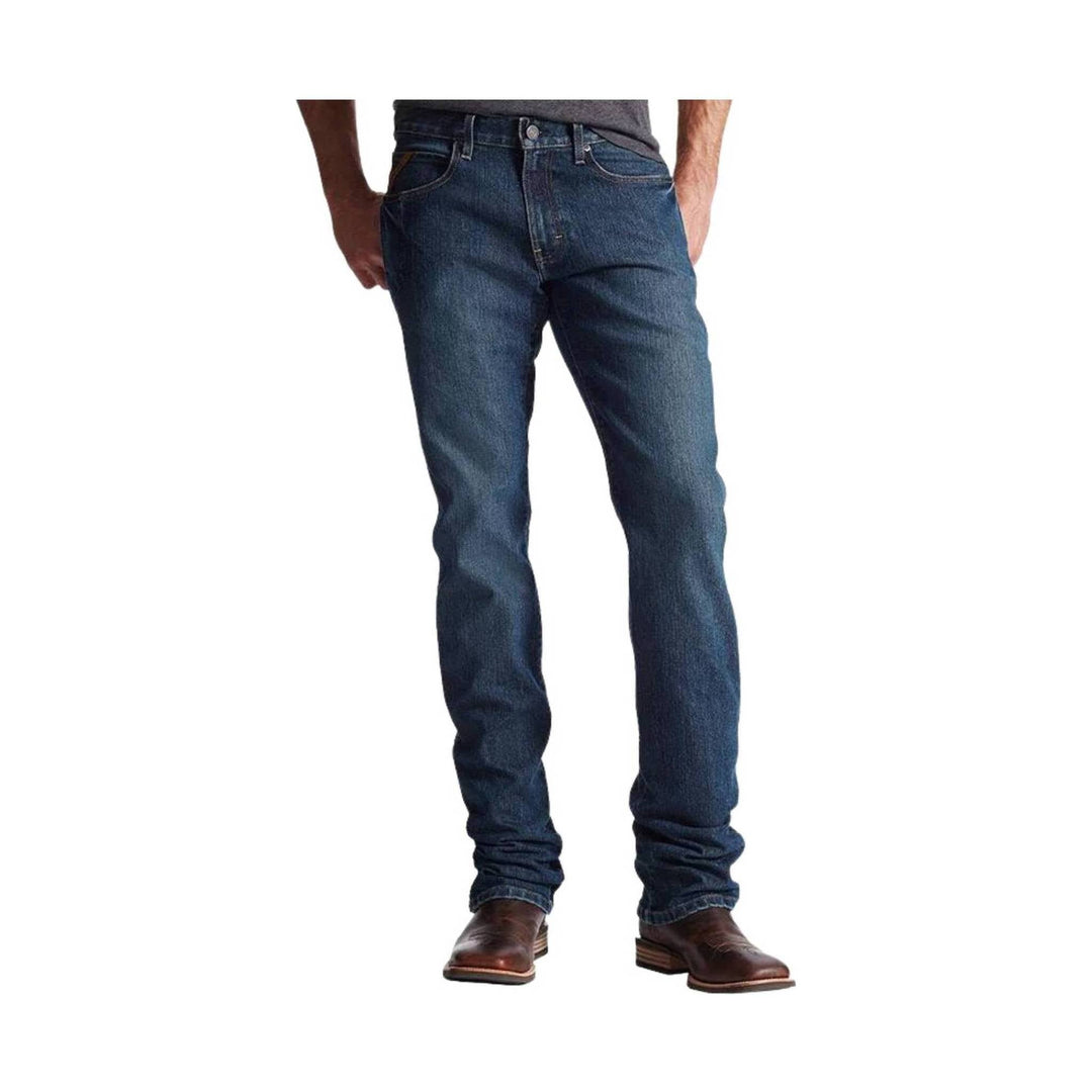 Dark blue boot-cut jeans shown on a model with brown boots