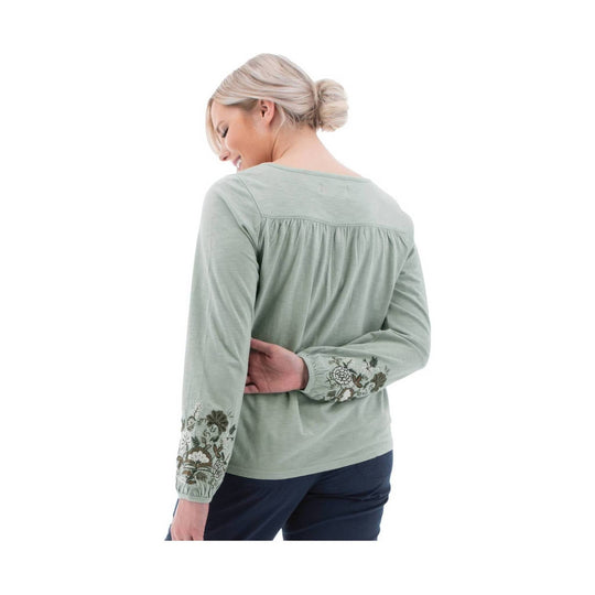 Light sage long-sleeve top with floral embroidery on the cuffs and back yoke, shown from the back