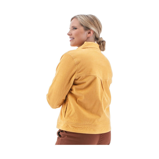 Mustard yellow women’s jacket shown from the back, paired with brown pants