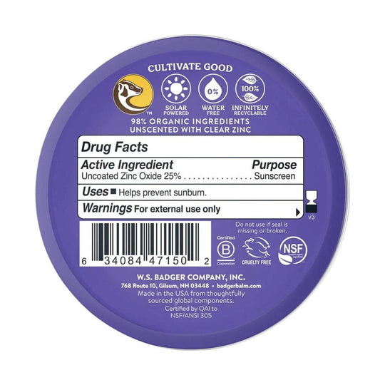 Purple round sunscreen tin with a Drug Facts label and visible text about 98% organic ingredients and unscented with clear zinc