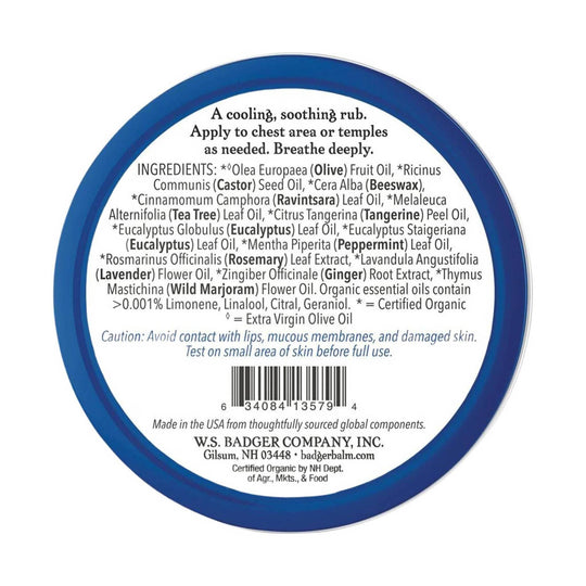 Round blue-lidded balm tin label with ingredient list, caution text, and barcode