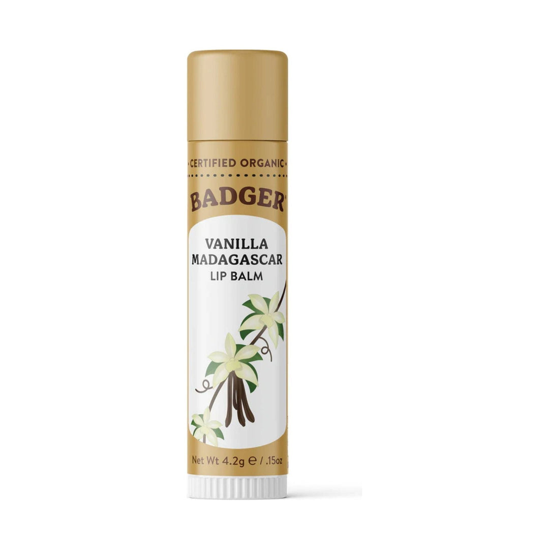 Gold tube lip balm with vanilla flower illustration and white base cap