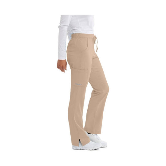 Beige cargo scrub pants with elastic waistband, side pockets, and white sneakers