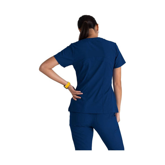 Back view of a navy short-sleeve scrub top and matching pants on a model