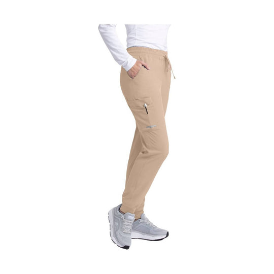 Khaki jogger scrub pants with elastic waistband, drawstring, side pockets, and zip cargo pocket, shown on model