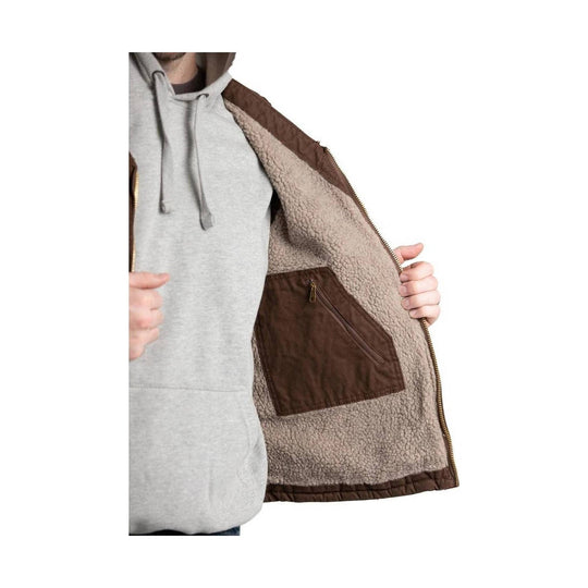 Brown sherpa-lined vest worn open over a gray hoodie, showing a zippered inner pocket