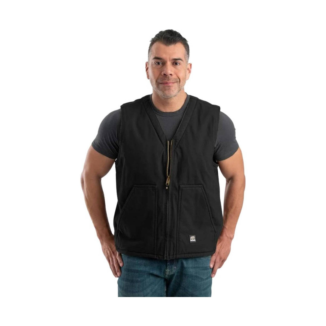 Black V-neck vest with zipper front and large front pockets, worn over a dark T-shirt