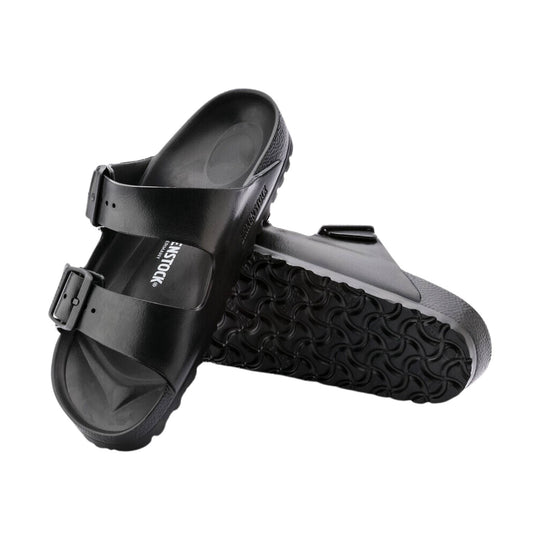 Black EVA slide sandals with dual straps, buckles, and contoured footbeds, shown overlapping on a white background