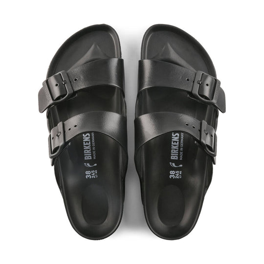Black two-strap sandals with adjustable buckles and molded footbeds, shown top-down.