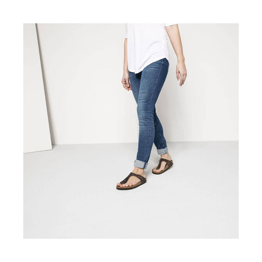 Brown thong sandals with cork soles, worn with cuffed jeans