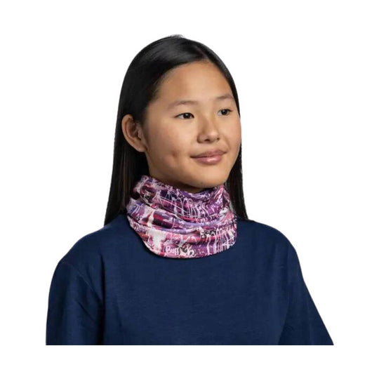 Purple patterned neck gaiter worn over a navy long-sleeve top