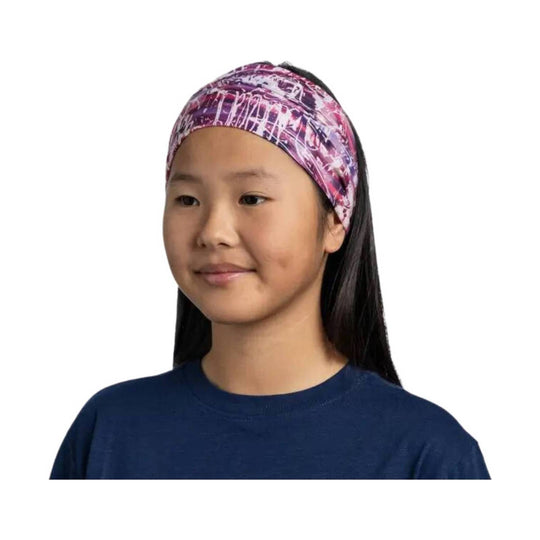 Purple patterned headband on a child wearing a navy shirt