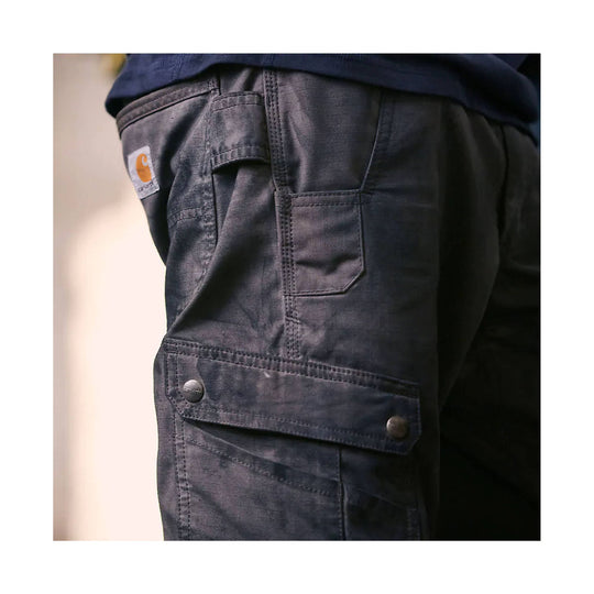 Dark cargo work pants with multiple side pockets and snap flaps