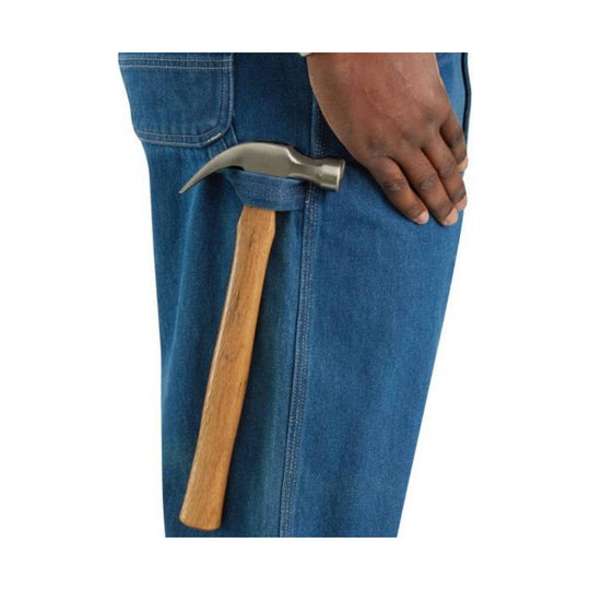 Denim bib overalls with side hammer loop and a hammer tucked into the pocket