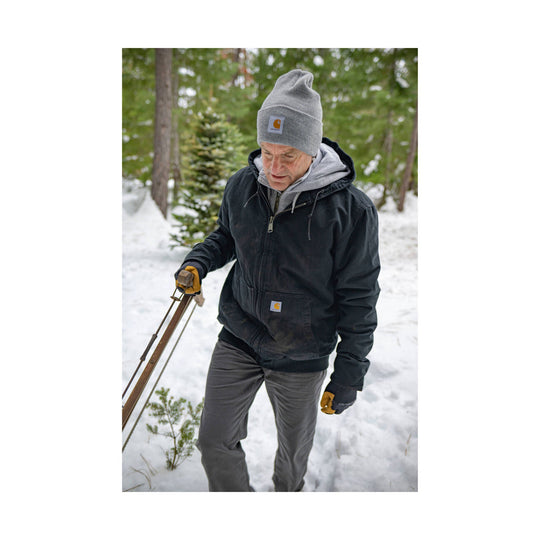 Black insulated hooded work jacket worn over a gray hoodie, shown outdoors in snow