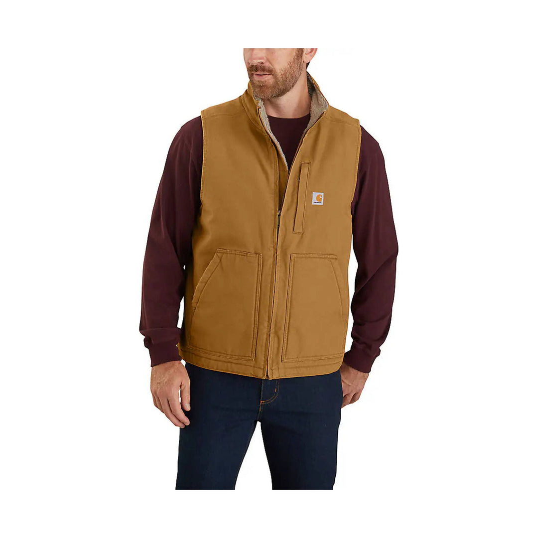 Brown sherpa-lined work vest with a front zipper, chest pocket, and logo patch, worn over a maroon long-sleeve shirt