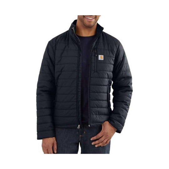 Black quilted insulated jacket worn over a dark shirt, with a stand collar and chest logo patch.
