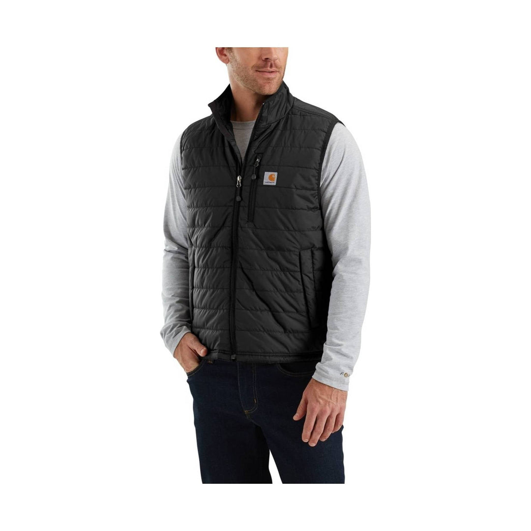 Black quilted insulated vest worn over a light gray long-sleeve shirt