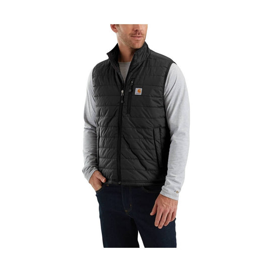 Black quilted insulated vest worn over a light gray long-sleeve shirt