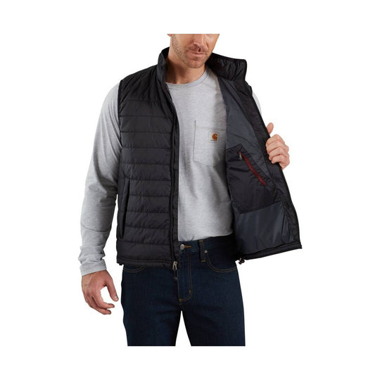 Black quilted insulated vest worn over a gray long-sleeve shirt, with a small chest logo patch