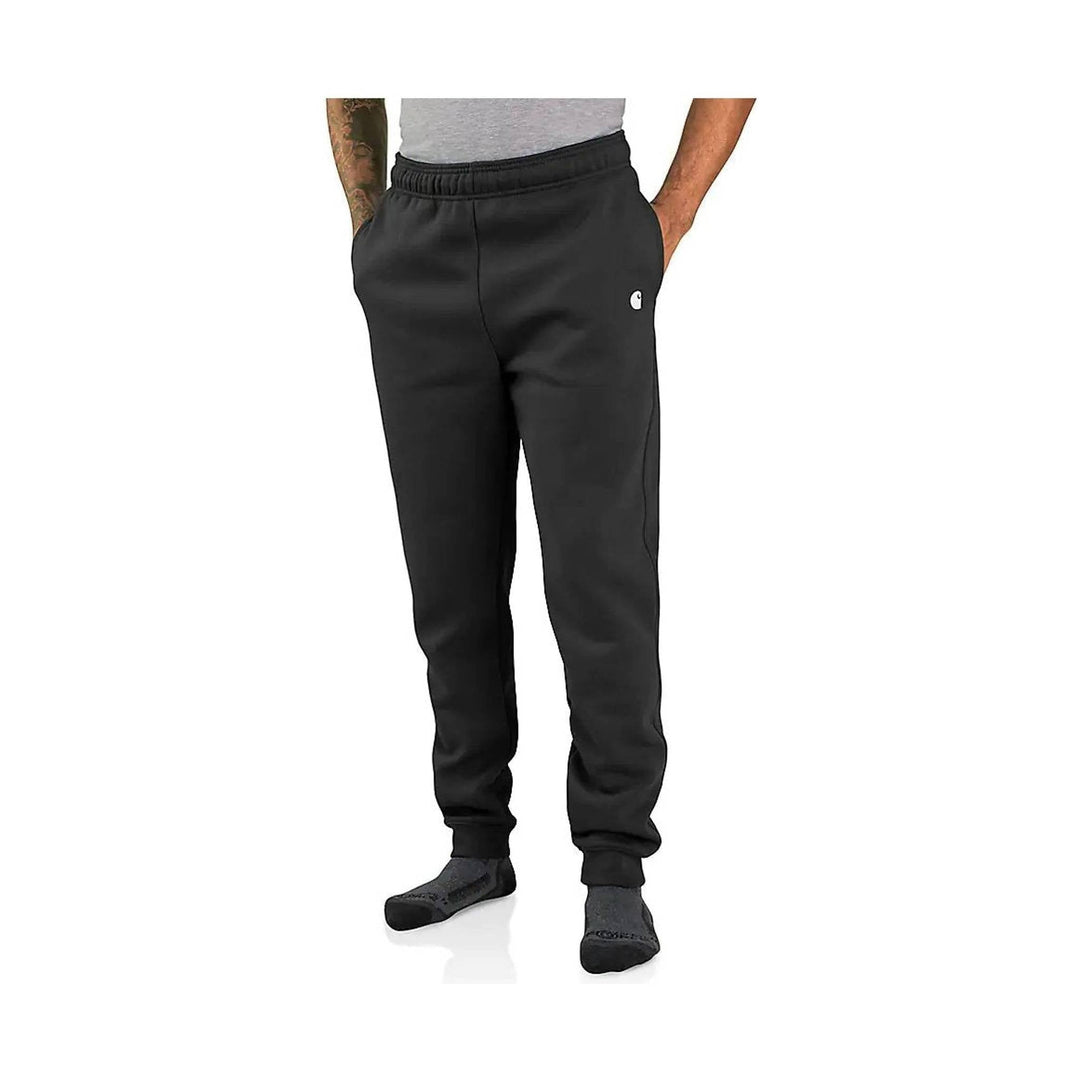 Black tapered sweatpants with elastic waistband and ankle cuffs, worn with dark socks