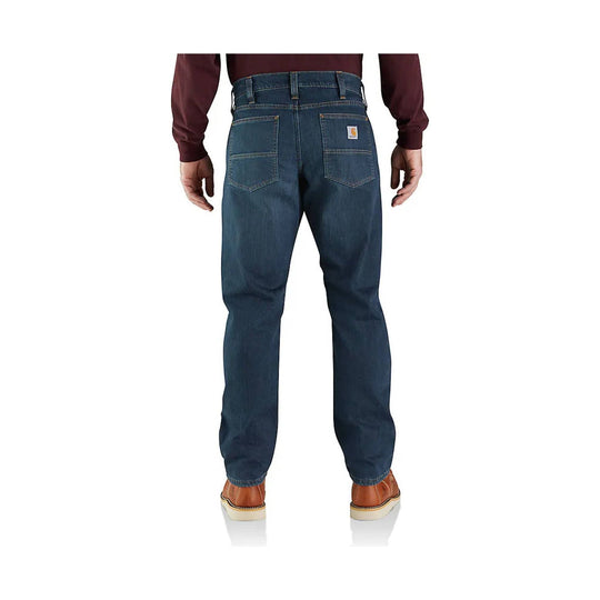 Dark blue denim jeans shown from the back with a Carhartt patch on the right rear pocket