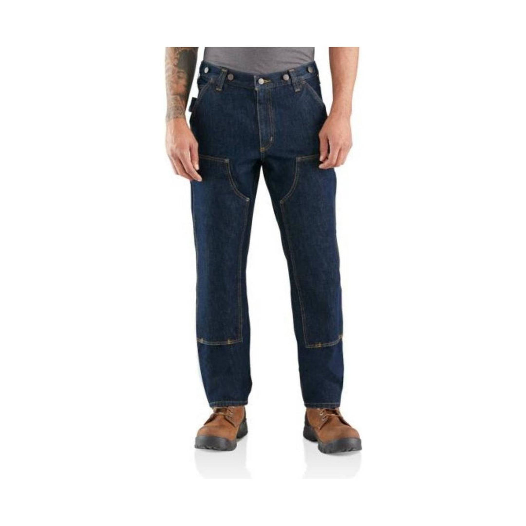 Dark blue work jeans with reinforced knees, front utility pockets, and brown work boots visible