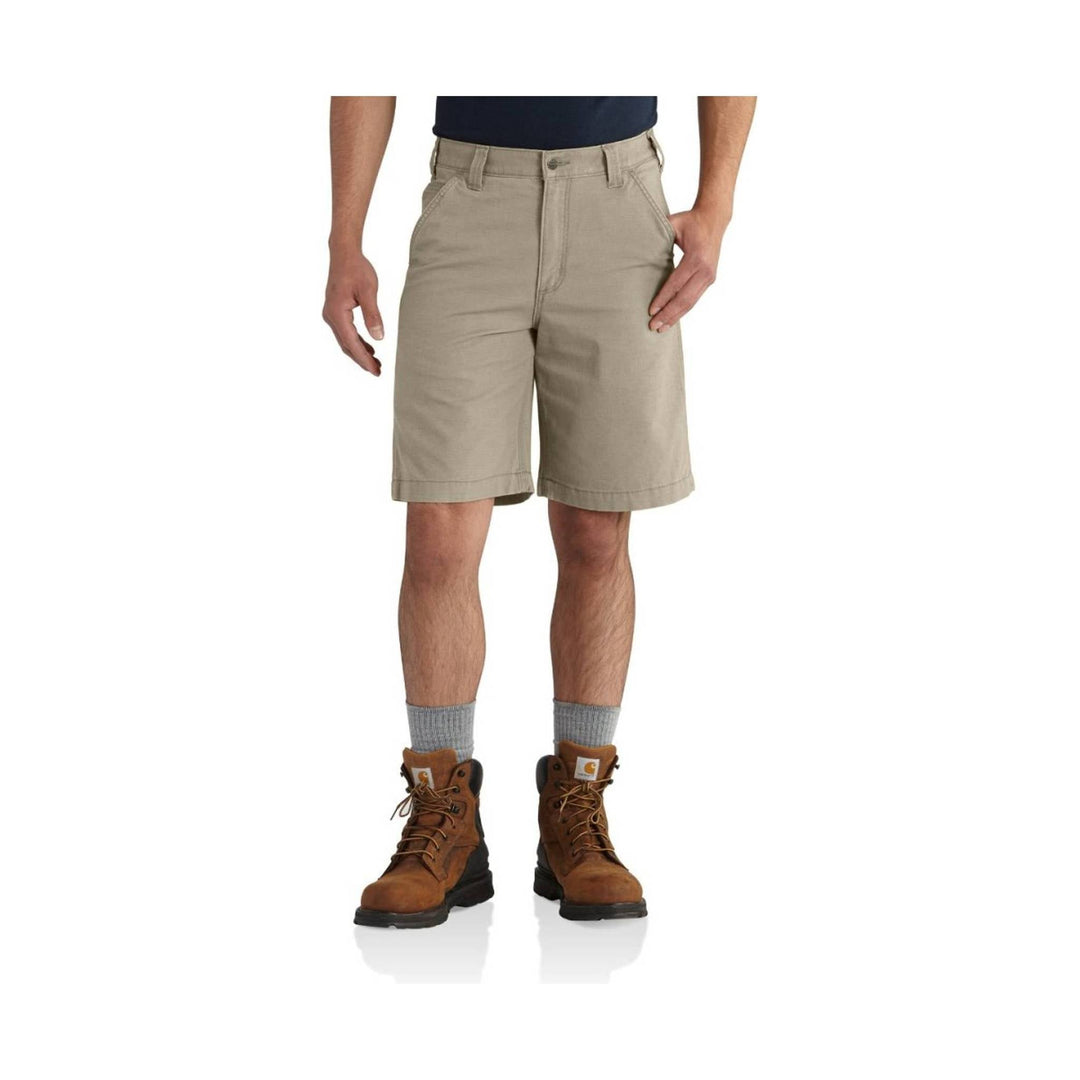 Tan knee-length shorts with belt loops, front pockets, and a button fly, worn with boots.