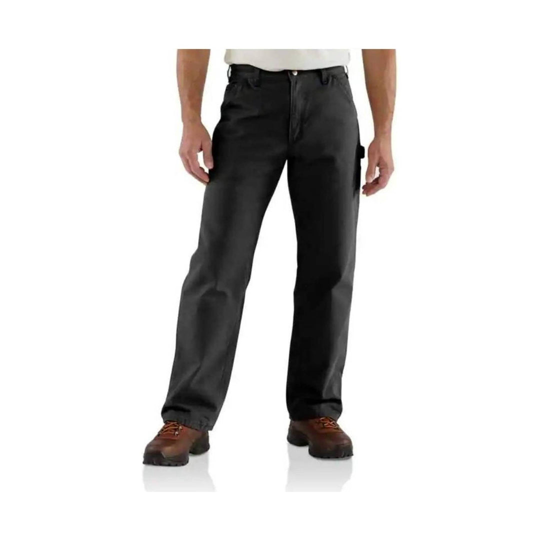 Black work pants with straight legs and utility pockets, worn with brown work boots
