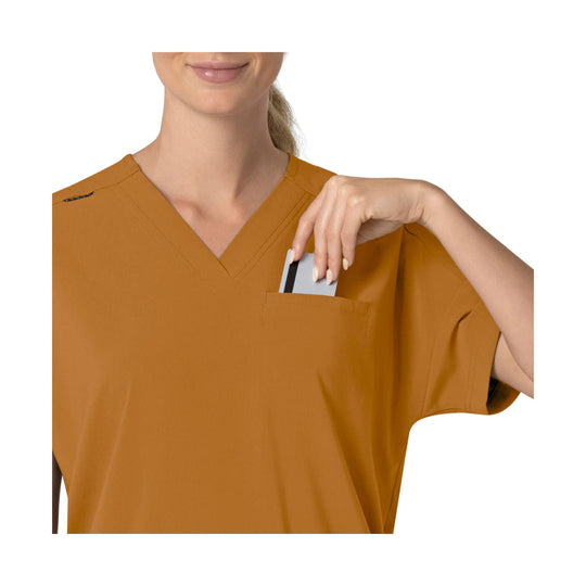 Rust-colored V-neck scrub top with a chest pocket, shown with a card tucked in the pocket