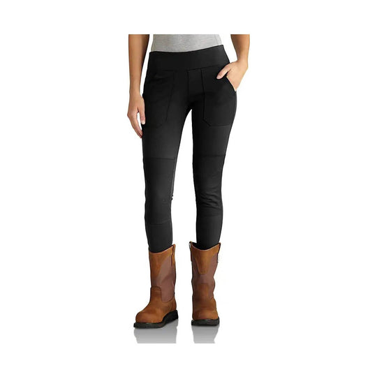 Black fitted utility leggings with front pockets and panel seams, shown with brown boots