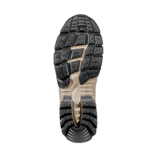 Black and tan rugged work boot outsole with deep tread blocks and heel grooves