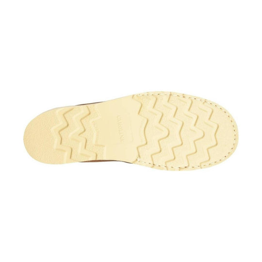 Cream-colored boot outsole with zigzag tread and stitched edge
