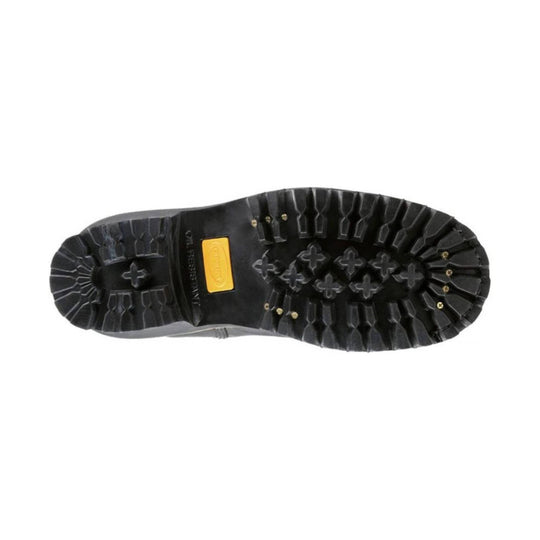 Black lugged boot outsole with deep tread and a yellow Vibram insert
