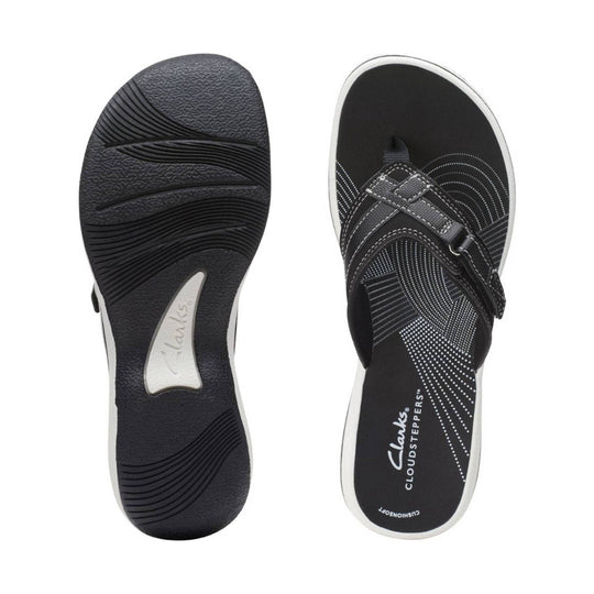 Black women’s sandal shown from sole and top views, with white trim, dotted footbed, and Clarks branding