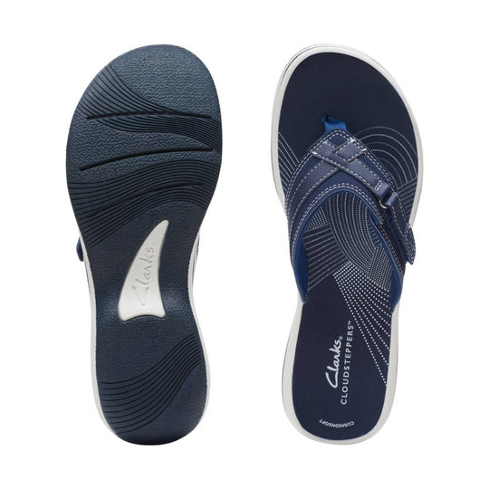 Navy slingback sandal with crisscross strap, buckle closure, and dotted insole print