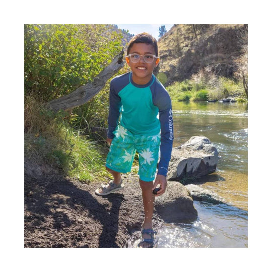 Teal long-sleeve sun shirt and tropical-print swim shorts with Columbia logo on the sleeve