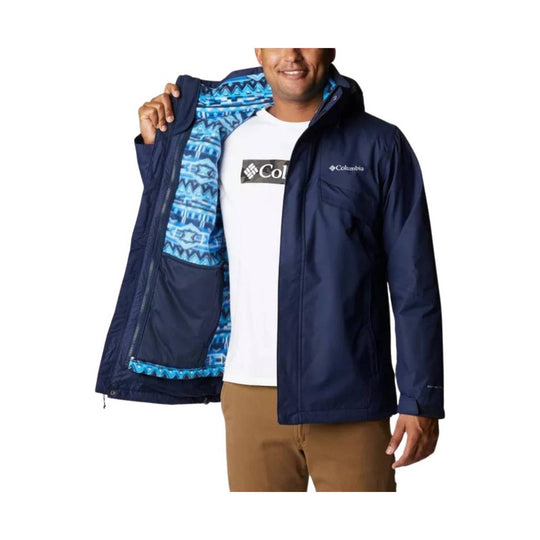 Navy zip-front jacket with bright blue patterned lining and small chest logo