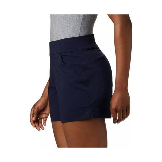 Navy athletic shorts with a wide high-rise waistband and side slit hem, shown on a model