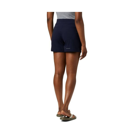 Navy athletic shorts shown from the back on a model