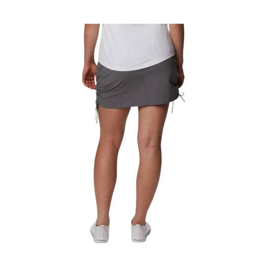 Gray athletic skort shown from the back on a model