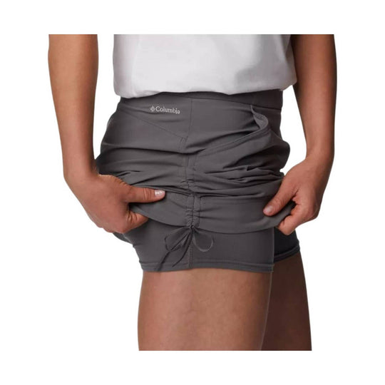 Gray athletic skort with ruched front and drawstring hem, shown on a model