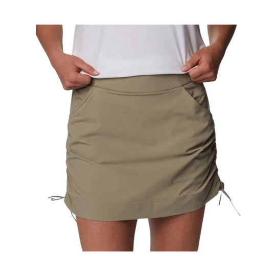 Beige athletic skort with front pockets and adjustable side drawcords