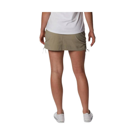 Khaki skort shown from the back with drawstring hems and a white top