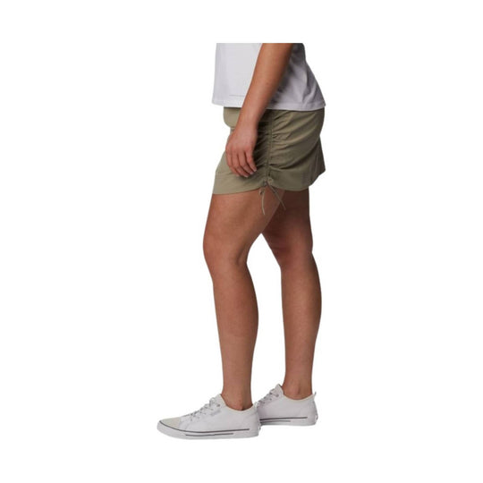 Olive drawstring skort shown on a model with white low-top sneakers