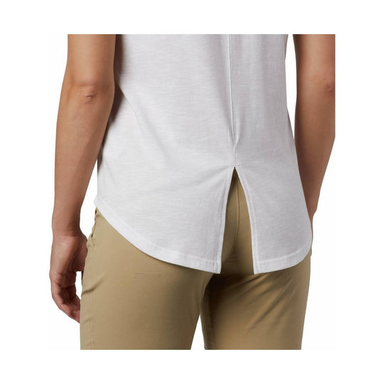 White sleeveless tank top with side slits, shown from the back with tan pants.