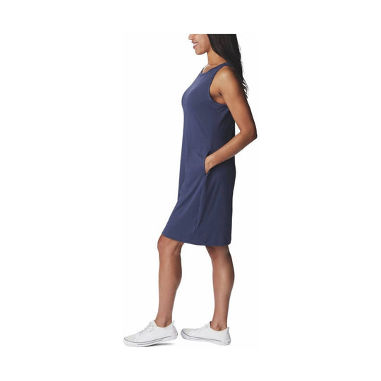 Navy sleeveless dress with scoop neckline and side pockets, shown on a model in side view