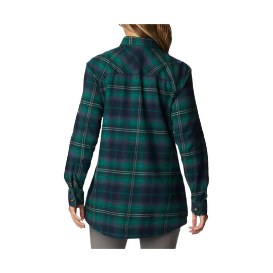 Back view of a green and navy plaid long-sleeve flannel shirt with a curved hem and button cuffs
